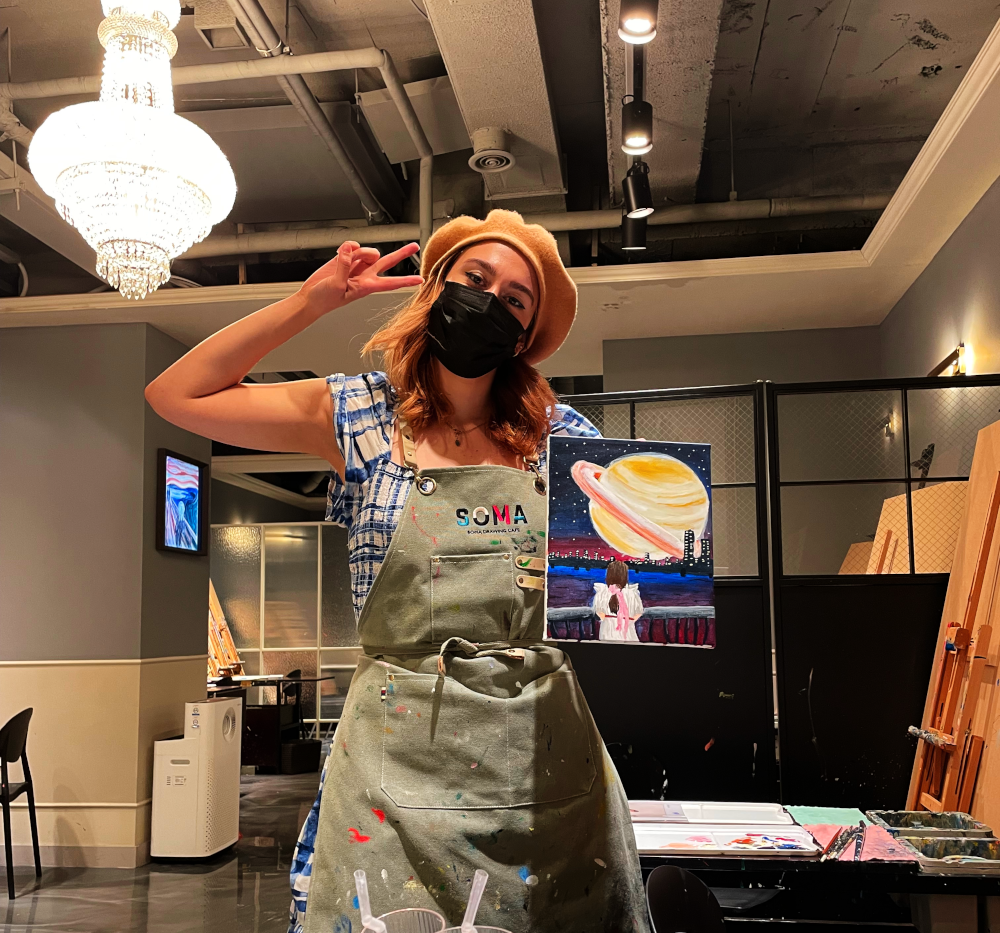 girl at painting café with painting